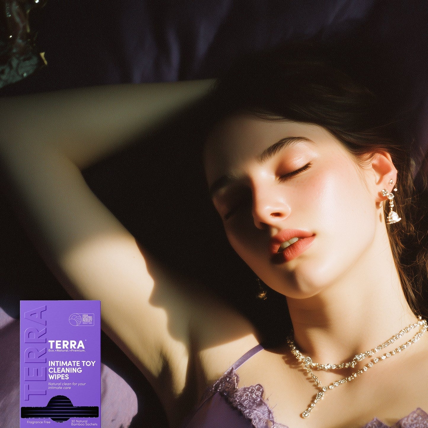 Woman lying down with a TERRA intimate toy cleaning wipes box in the foreground